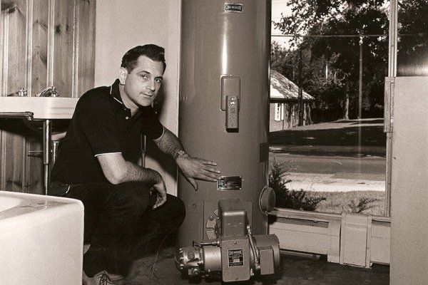 A Gottier man installing a water heater in the 1960s