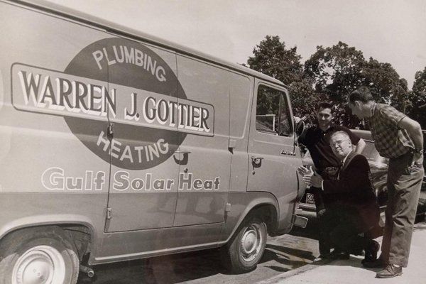The original Warren J. Gottier Plumbing and Heating van with the founders, photographed in the 1960s
